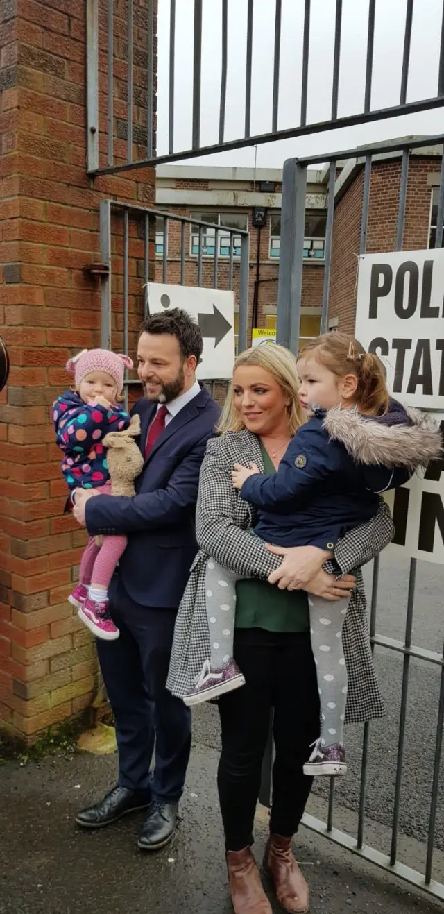 SDLP leader Colum Eastwood, accompanied by his family, voted at a polling station in Londonderry