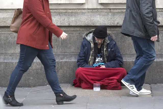 Homeless man sitting on a street