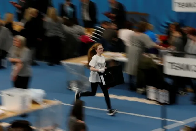 A runner carries a ballot box in Sunderland