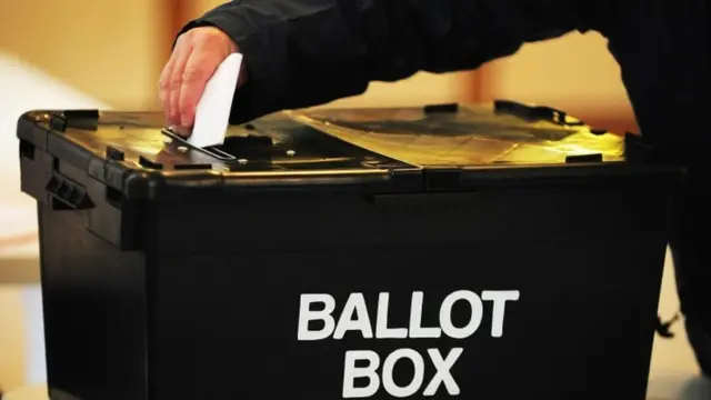 Ballot paper being dropped into ballot box