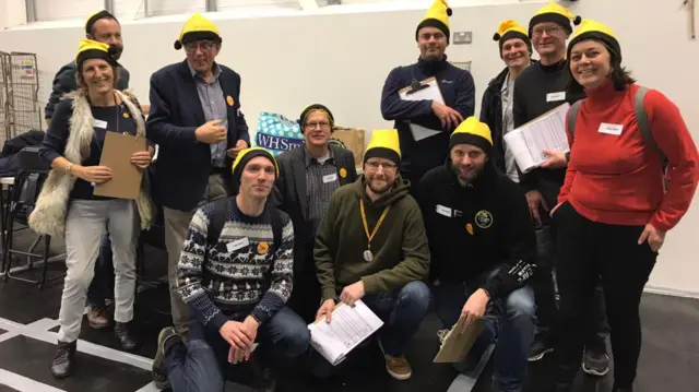 Lib Dems wearing yellow Santa hats in Hitchin and Harpenden