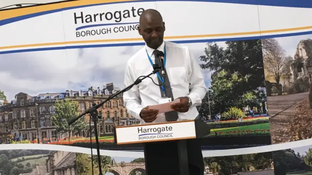 Returning officer at a podium