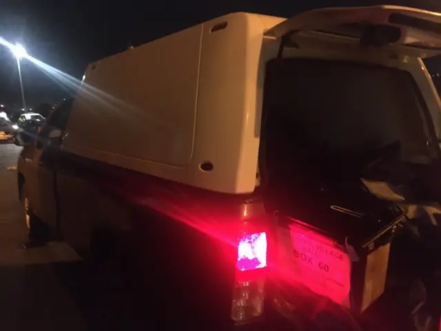 Pick-up truck with open boot containing ballot boxes