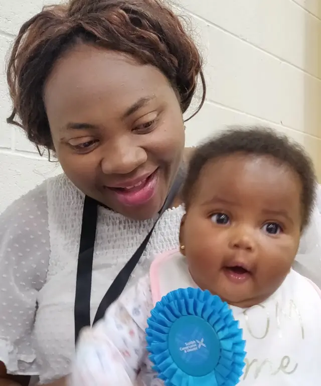 Mother and baby wearing Conservative rosette