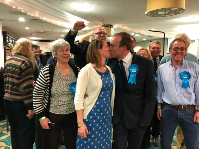 Newcastle-under-Lyme MP Aaron Bell kisses his wife after election victory