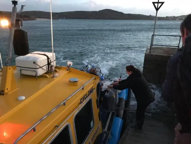 Photo of ballot box being loaded onto the jet boat on Bryher