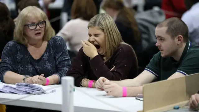 A member of the counting staff yawns during the count in Glasgow