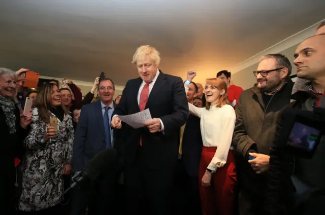 Britain's Prime Minister Boris Johnson (C) is cheered by supporters on a visit to meet newly-elected Conservative party MP for Sedgefield