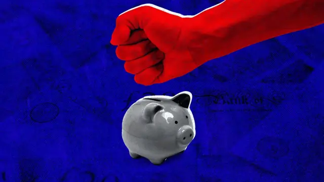 Fist about to break piggy bank