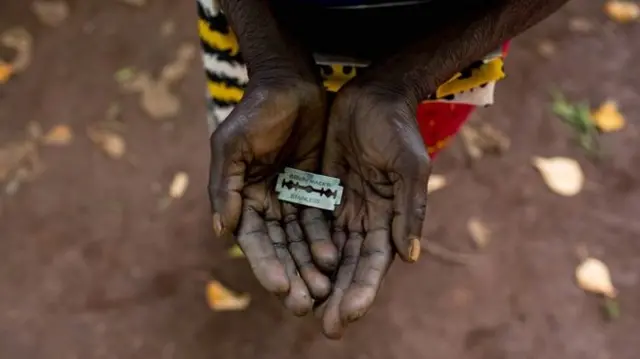 Hands cupping razor blade