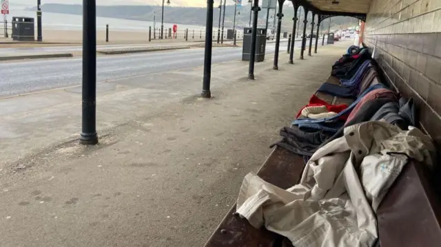 COATS LEFT ON BENCHES