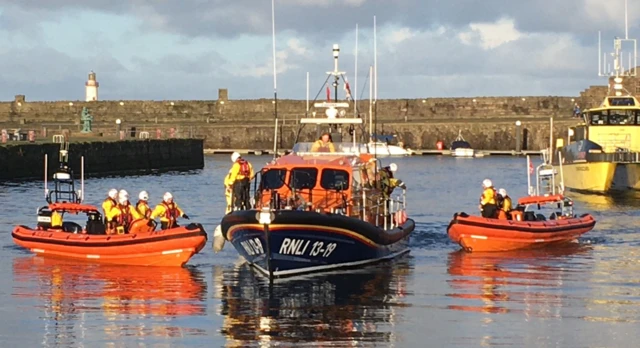 Lifeboats with reflection in water