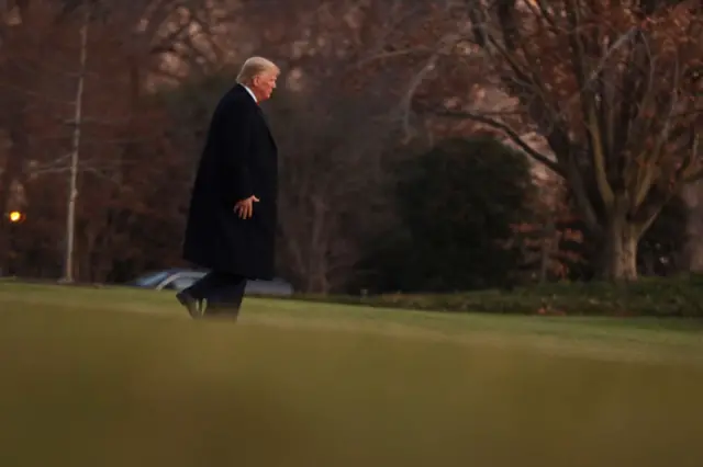 Donald Trump walks towards Marine One