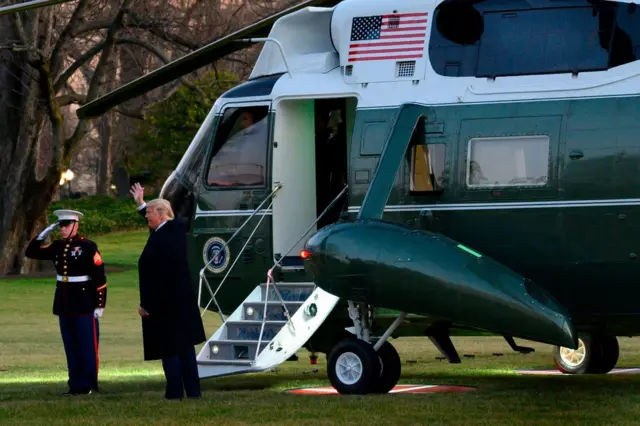 Donald Trump waves again as he prepares to board the helicopter