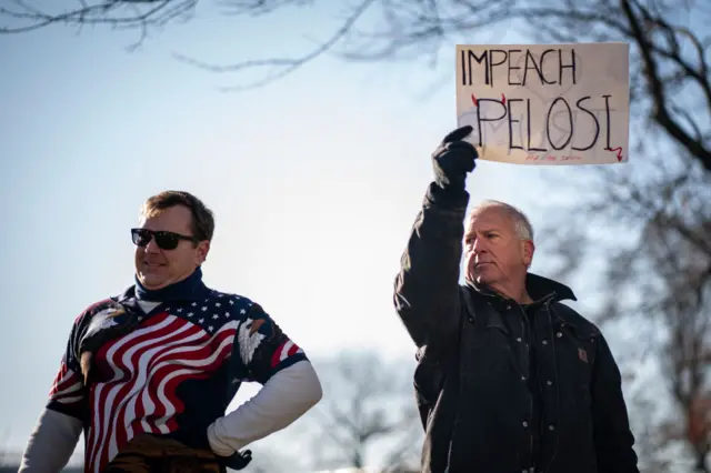 A man stood with a sign saying "impeach Pelosi" in Washington DC