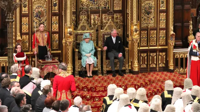 Queen Elizabeth II and the Prince of Wales sit in the chamber ahead of the State Opening of Parliament by the Queen, in the House of Lords at the Palace of Westminster in London.