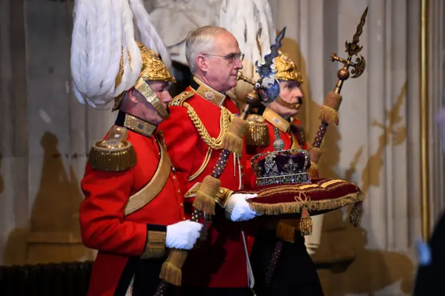 Gentlemen at Arms carry the Imperial State Crown through the Sovereign"s entrance for the State Opening of Parliament by Britain"s Queen Elizabeth in the House of Lords at the Palace of Westminster in London,