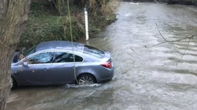 Car driving through flood