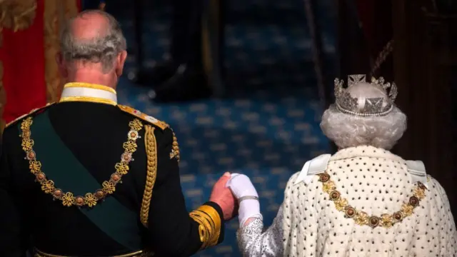 Prince of Wales holds the Queen's hand