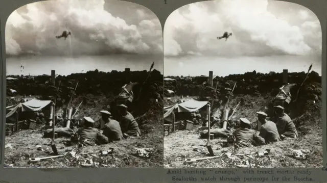 Stereoscope showing soldiers in the trenches, manning a mortar as they watch through a periscope