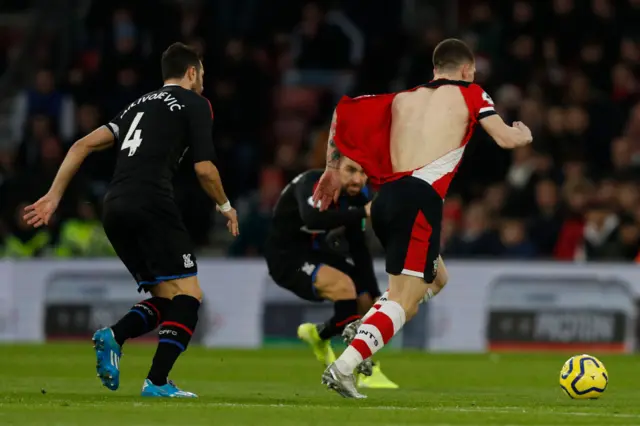 Pierre-Emile Hojbjerg's (R) shirt is ripped by Crystal Palace's Serbian midfielder Luka Milivojevic