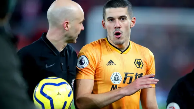 Conor Coady speaking to referee during match