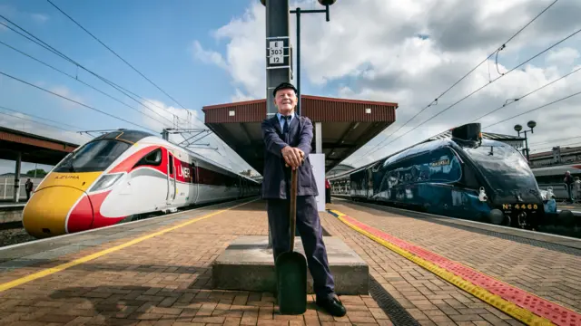 Steam traction inspector Jim Smith is pictured with a new Azuma train standing alongside the Mallard steam locomotive at York Station, Yorkshire, as London North East Railway's new Azuma service is launched.