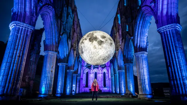 Luke Jerram's 'Museum of the Moon' at English Heritage's Illuminating Rievaulx installation at Rievaulx Abbey, near Helmsley, North Yorkshire.