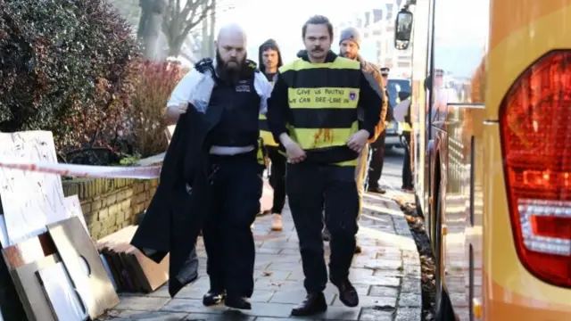 Protester dressed as a bee is arrested in south London