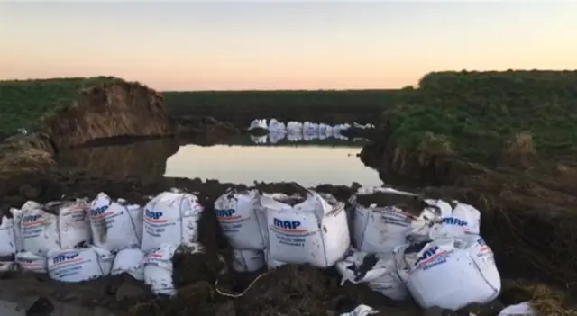 Sandbags at river breach