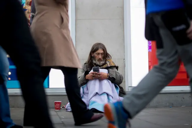 A homeless man, who's been rough sleeping for five years, begs in central London last month