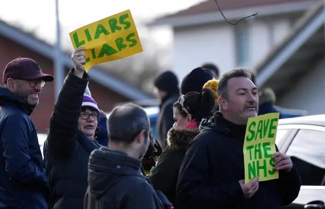 Protesters gather to demonstrate against British Prime Minister Boris Johnson as he campaigns on December 7, 2019 in Cheadle Hulme, United Kingdom.