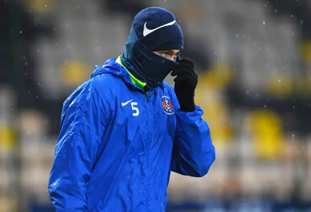 Kilmarnock's Connor Johnson is well wrapped up to combat the poor weather in West Lothian