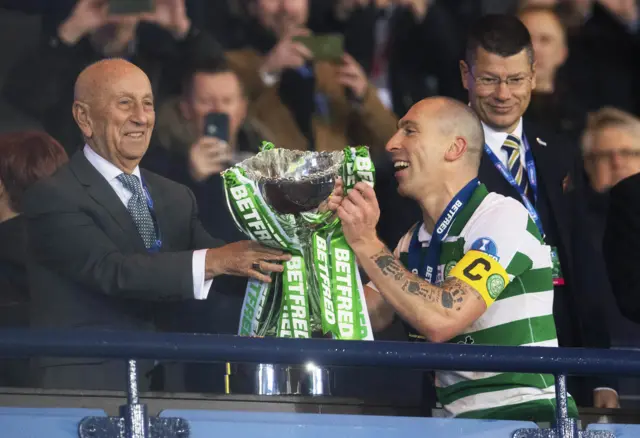 Celtic captain Scott Brown collects the Scottish League Cup for the fourth year running