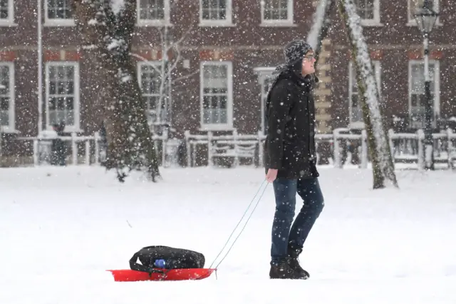 A man pulls a sled through the snow on February 01, 2019 in Bristol, England.