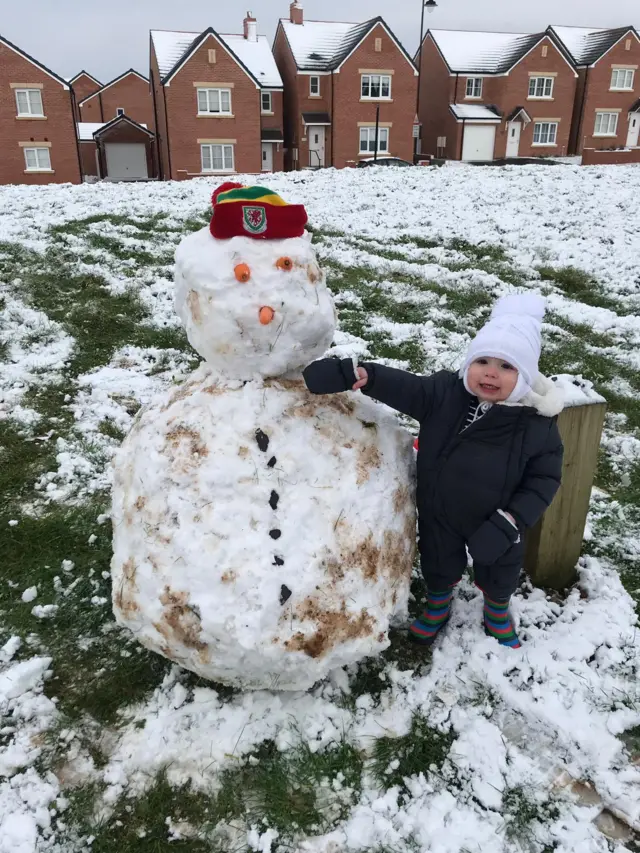 toddler with a snowman