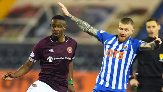 Hearts' Arnaud Djoum and Alan Power in action