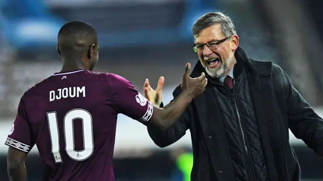 Hearts' Arnaud Djoum celebrates with manager Craig Levein