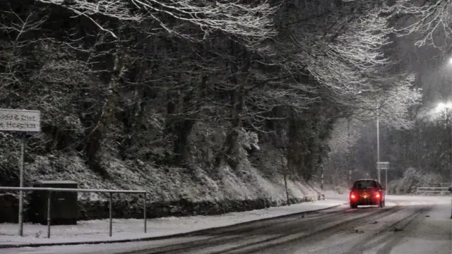 Car driving through snowy conditions