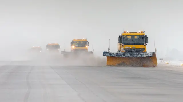 Staff work to clear the runway at RAF Brize Norton.