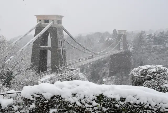 Snow is seen covering the area around the Clifton Suspension Bridge