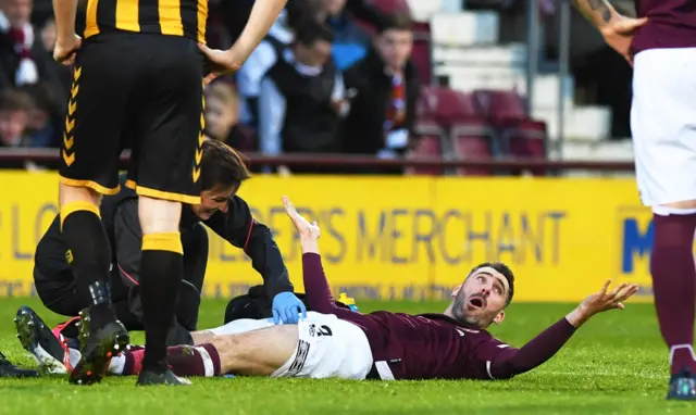 Hearts defender Michael Smith receives treatment