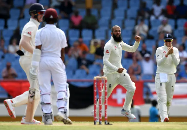 Moeen Ali of England (c) celebrates taking the wicket of Shane Dowrich