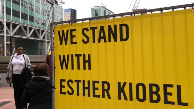 An Amnesty International banner displayed outside the court in support of one of the widows expected to testify, Esther Kiobel.