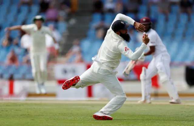 England's Moeen Ali takes a catch to dismiss West Indies' John Campbell