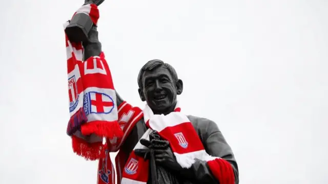 Scarves are left on a statue of Gordon Banks outside the stadium