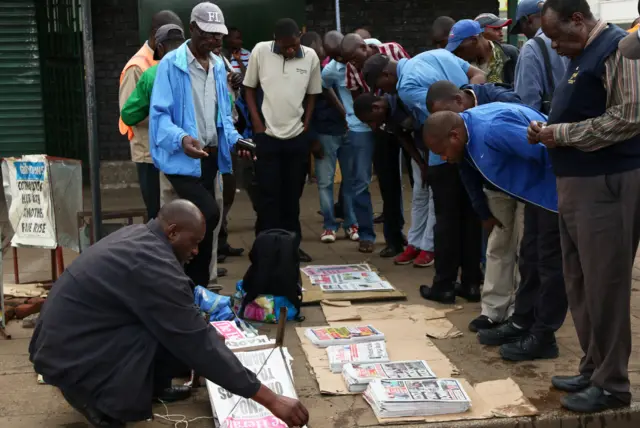 People reading newspapers