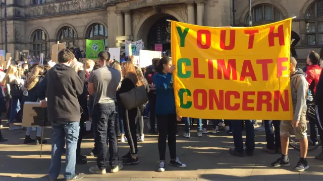 People at the protest with a banner