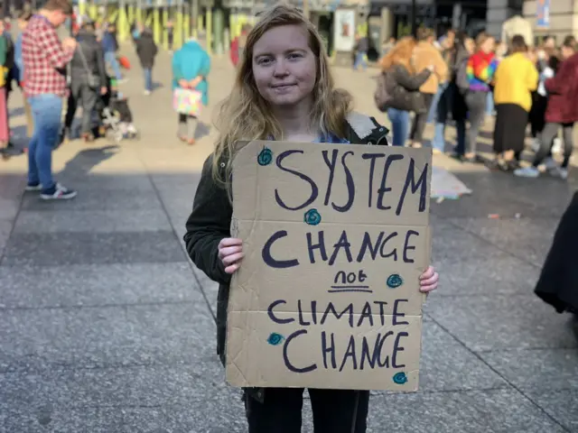 Teenager holds up protest sign