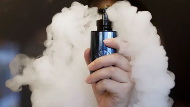 Someone using an e-cigarette